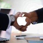amsys recruitment represented by handshake under apple logo
